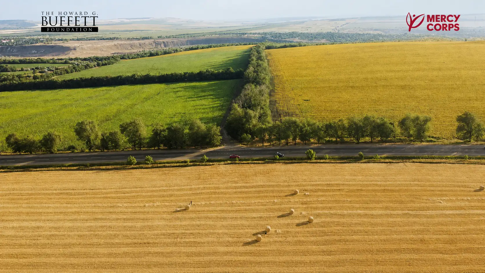 Аерофотознімок сільськогосподарських полів із логотипами Фонду Говарда Баффета та Mercy Corps.